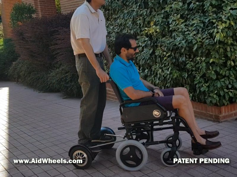 Caregiver power assist wheelchair